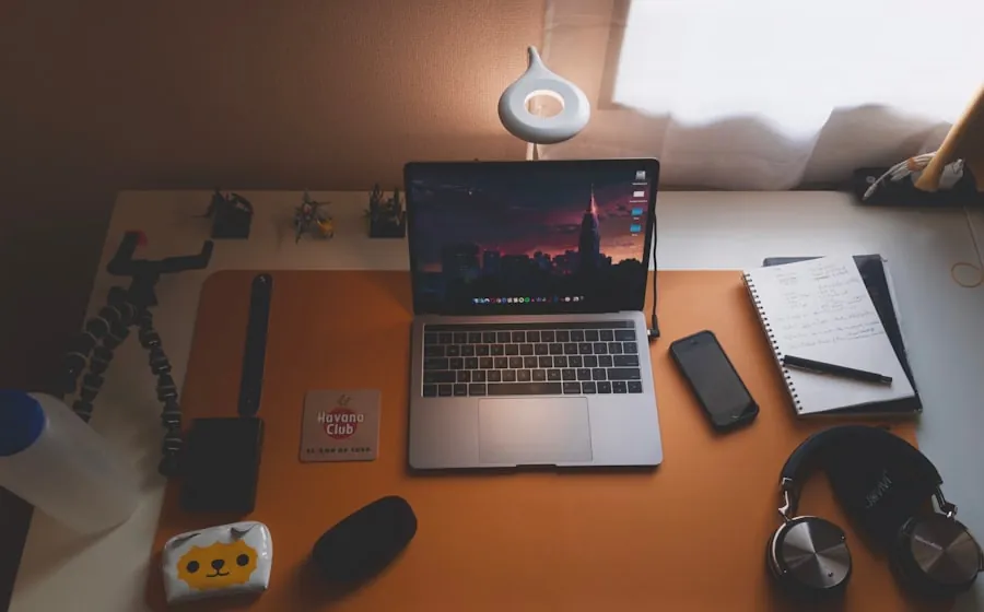 Laptop and notebook on a desk, set up for a live IP training session